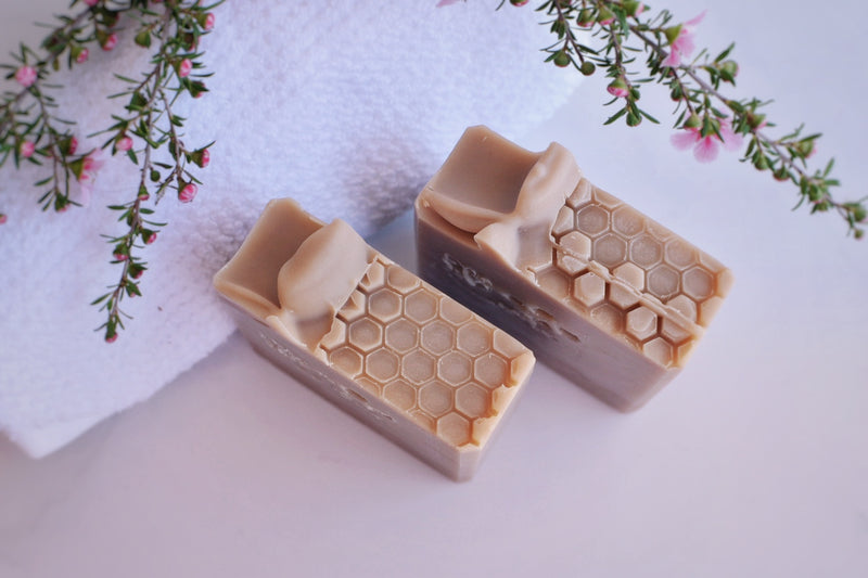 Two Beige soaps with a topping that looks like a bee hive 
